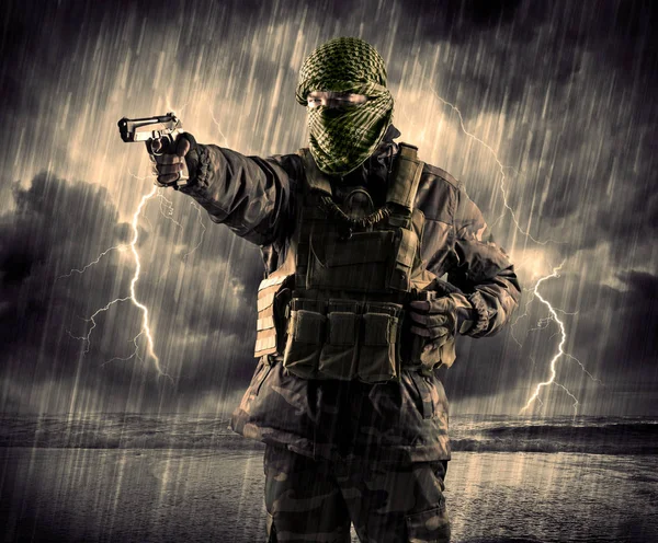 Dangerous armed terrorist with mask and gun in a thunderstorm wi — Stock Photo, Image