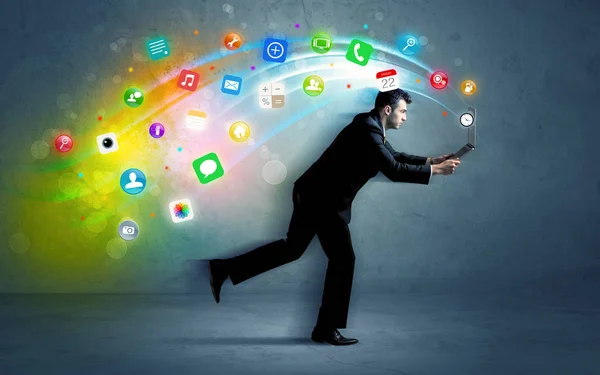 Running businessman with application icons from device — Stock Photo, Image