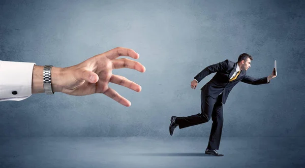 Businessman running from hand — Stock Photo, Image