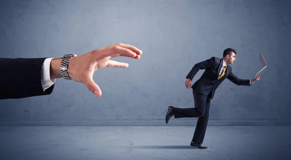 Businessman running from hand — Stock Photo, Image