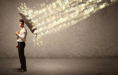 İş adamı dolar yağmuruna karşı şemsiye tutuyor