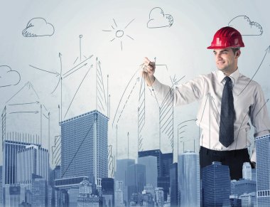 Genç işçi şehir manzarası çiziyor.