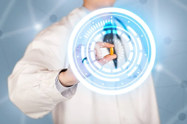 Male doctor holding a pill with glowing circles — Stock Photo, Image