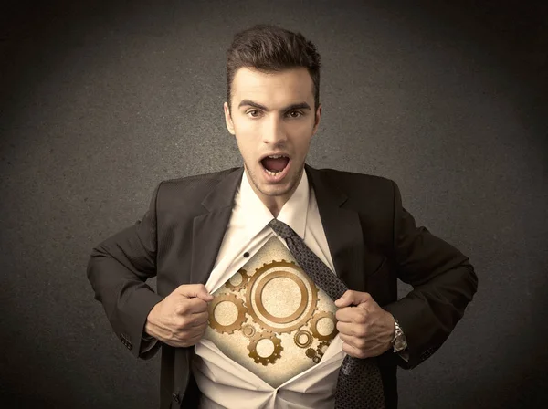 Businessman tearing shirt off and machine cog wheel shows — Stock Photo, Image