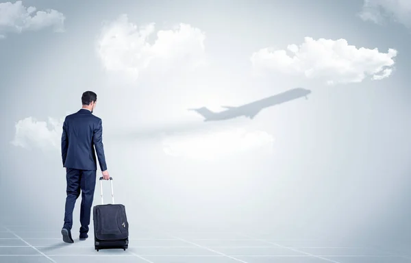 Businessman with luggage  look to an airplane — Stock Photo, Image