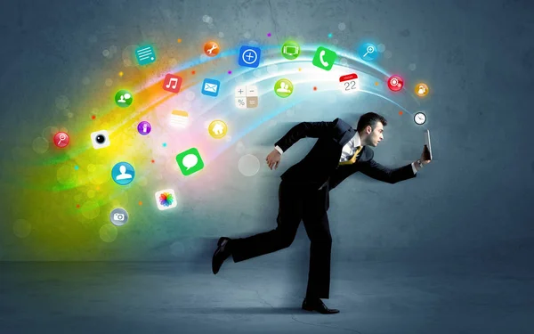 Running businessman with application icons from device — Stock Photo, Image