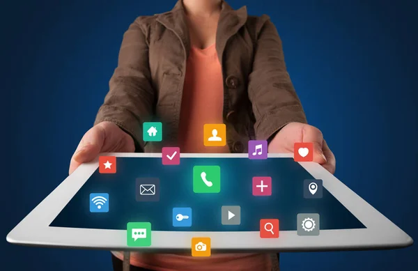 Woman holding tablet with multimedia graphics — Stock Photo, Image