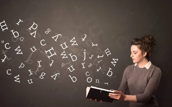 Young lady holding book with letters — Stock Photo, Image