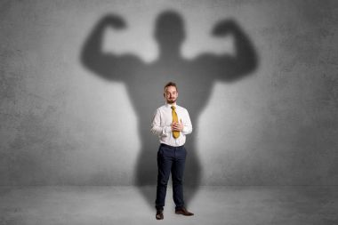 Businessman with muscular shade behind his back clipart