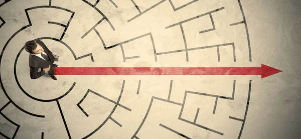 Business person standing in the middle of a circular maze — Stock Photo, Image