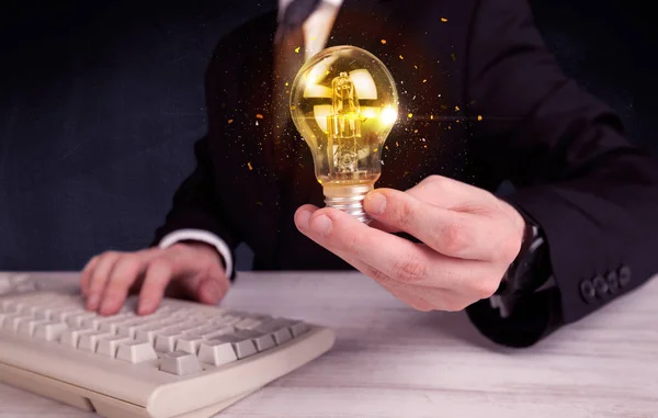 Office worker holding a light bulb — Stock Photo, Image