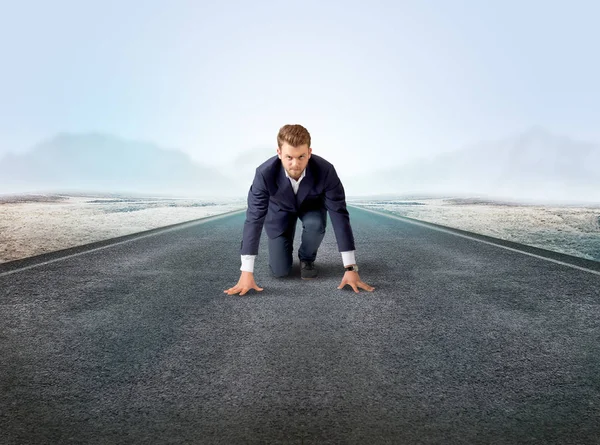 Businessman kneeling in ready position Stock Photo