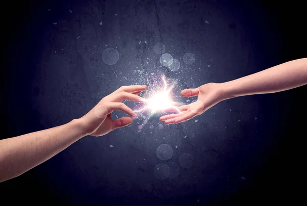 Hands reaching to light a spark — Stock Photo, Image