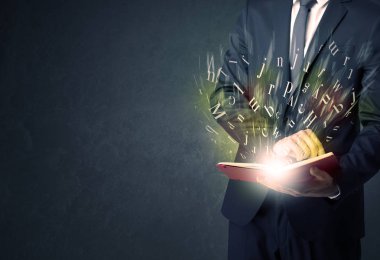 Elinde kitap tutan bir işadamı.