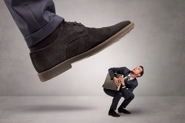 Small man trampled by the great power — Stock Photo, Image