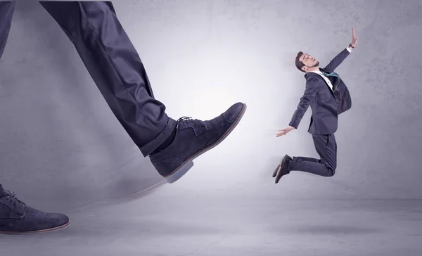 Foot kicking, businessman flying — Stock Photo, Image