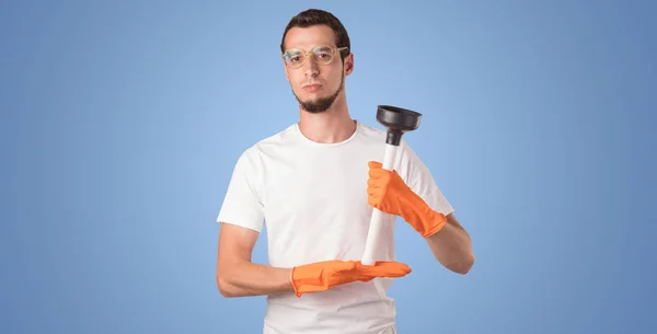 Housekeeper in front of a blue empty wall — Stock Photo, Image