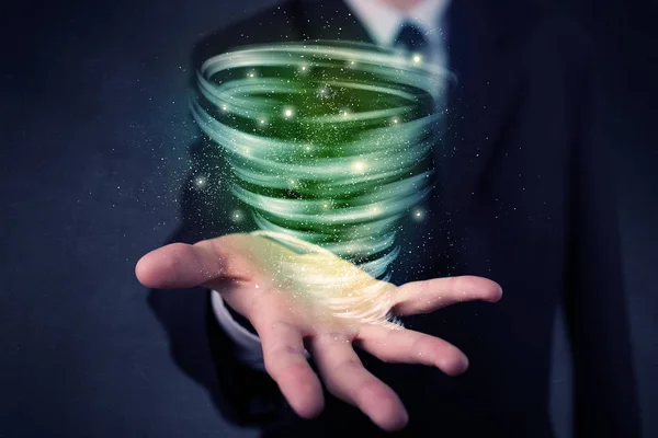 Businessman holding green tornado — Stock Photo, Image
