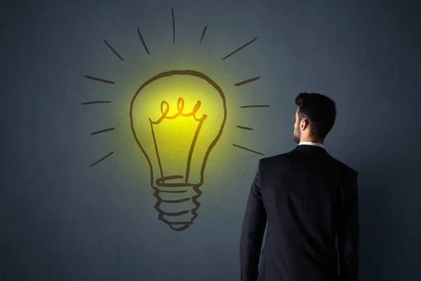 Businessman with lightbulb — Stock Photo, Image