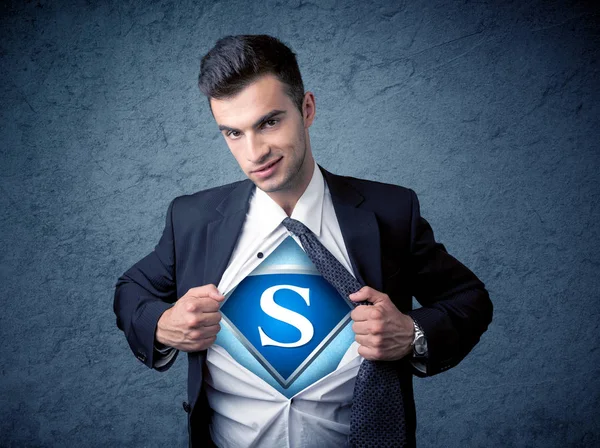 Businessman ripping off his shirt with superhero sign — Stock Photo, Image