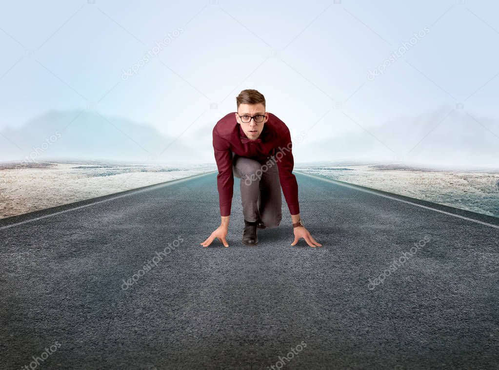 Businessman kneeling in ready position