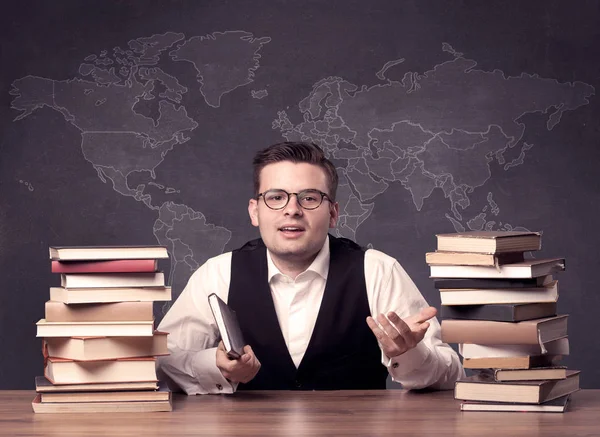 Geography teacher at desk — Stock Photo, Image