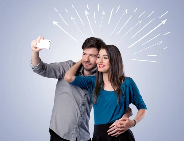 Cute couple taking selfie with arrows — Stock Photo, Image