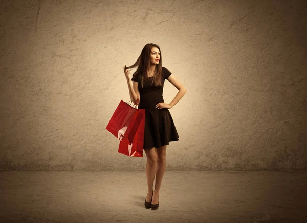 Shopping meisje met tassen en duidelijke achtergrond — Stockfoto