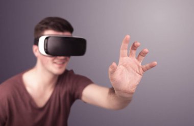 Adam sanal gerçeklik gözlüğü takıyor.