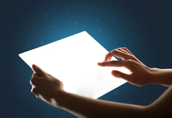 Hands touching a glass-like tablet — Stock Photo, Image