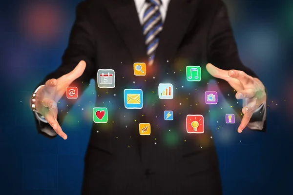 Businessman holding application icons — Stock Photo, Image