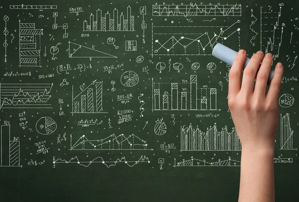 A business person drawing data on chalkboard — Stock Photo, Image