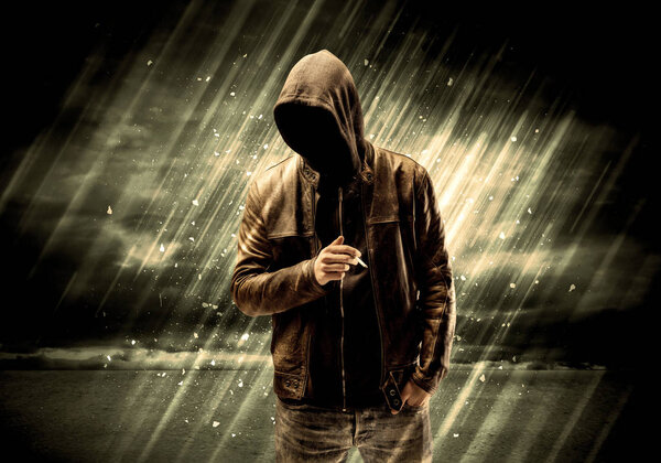 Dangerous criminal standing with cigarette