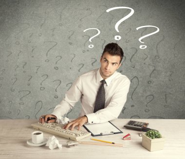 İş adamı soru işaretiyle masada.