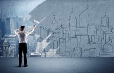 Zarif satıcı şehri duvarda yeniden boyuyor.