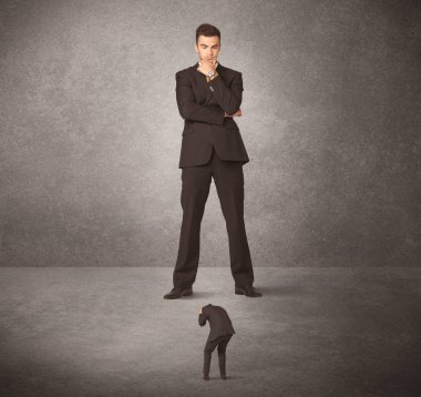 Büyük iş adamı küçük işçilere bakıyor.