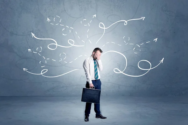 Businessman standing with winding arrows around — Stock Photo, Image