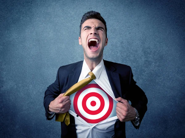 Businessman tearing shirt with target sign on his chest — Stock Photo, Image