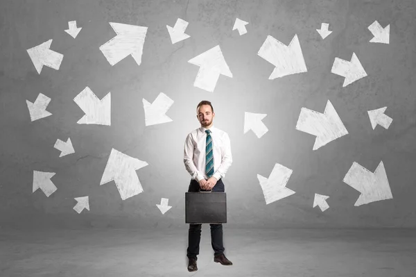 Businessman standing with arrows around — Stock Photo, Image