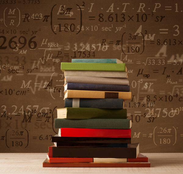 Books on vintage background with math formulas 