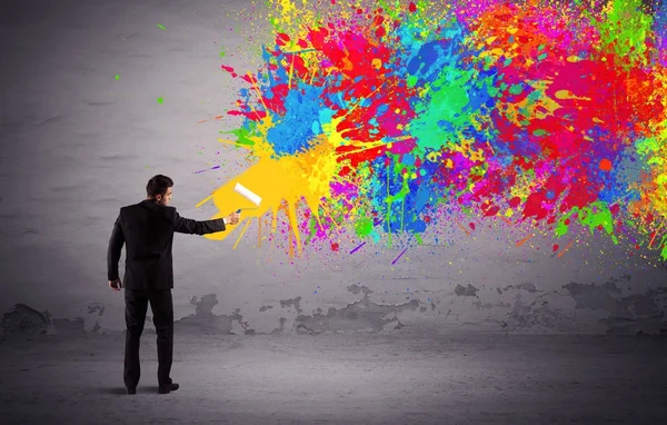 Sales person painting colorful splatter — Stock Photo, Image