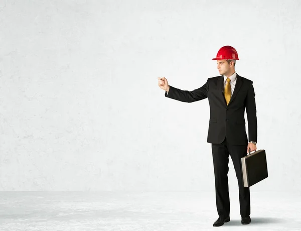 Young architect drawing in empty space — Stock Photo, Image