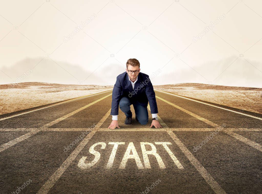 Businessman kneeling in ready position