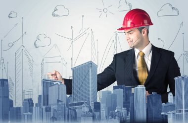 Genç işçi şehir manzarası çiziyor.