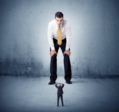 Öfkeli büyük iş adamı küçük adama lokma atıyor.