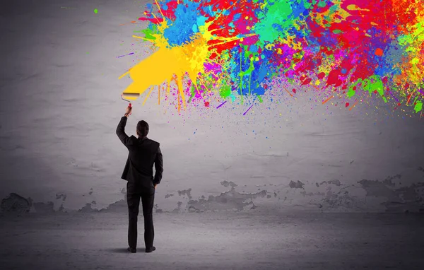 Sales person painting colorful splatter — Stock Photo, Image