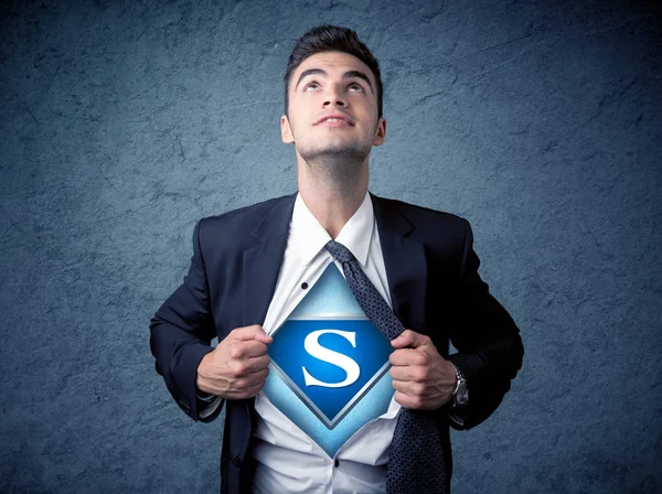 Businessman ripping off his shirt with superhero sign — Stock Photo, Image