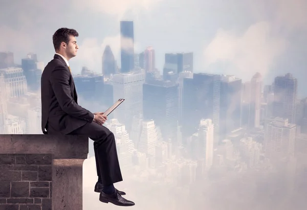 Sales person sitting on top of a tall building — Stock Photo, Image