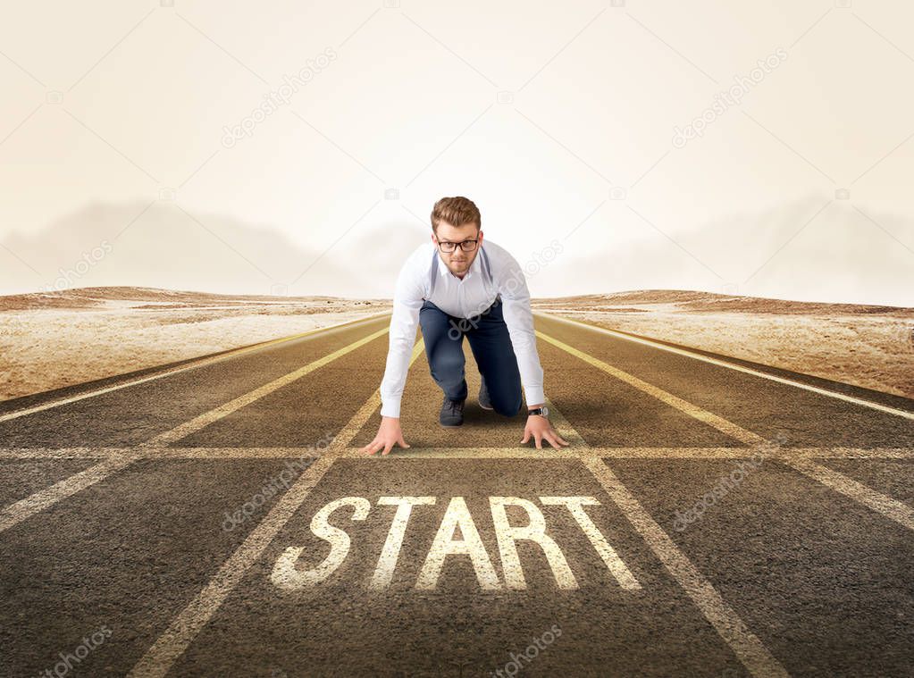 Businessman kneeling in ready position