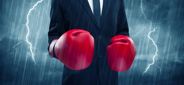 Businessman boxing in rain — Stock Photo, Image